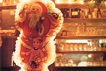 A Santa Claus illumination, a little girl looks happy to ring a bell. Frankfurt