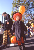 Walking with a pumpkin bag in a hand.