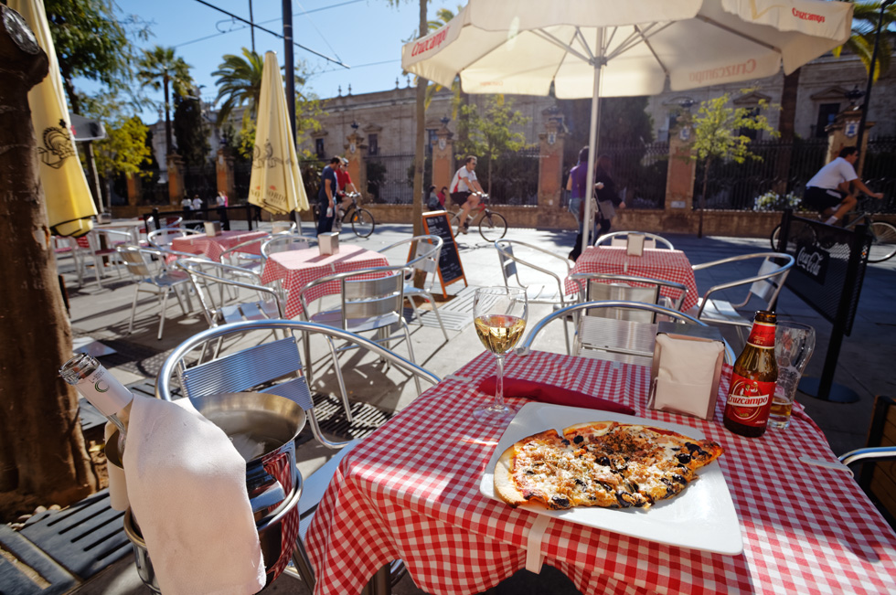 Pizza lunch on the terrace table facing the street in Sevilla